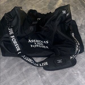 Black Travel Bag by Assholes Live Forever